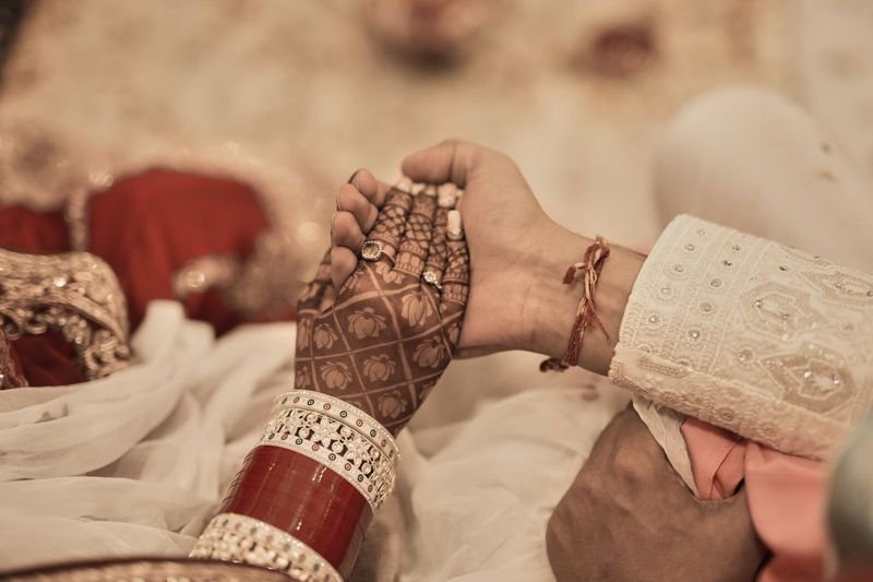 Wedding rings, hands touching