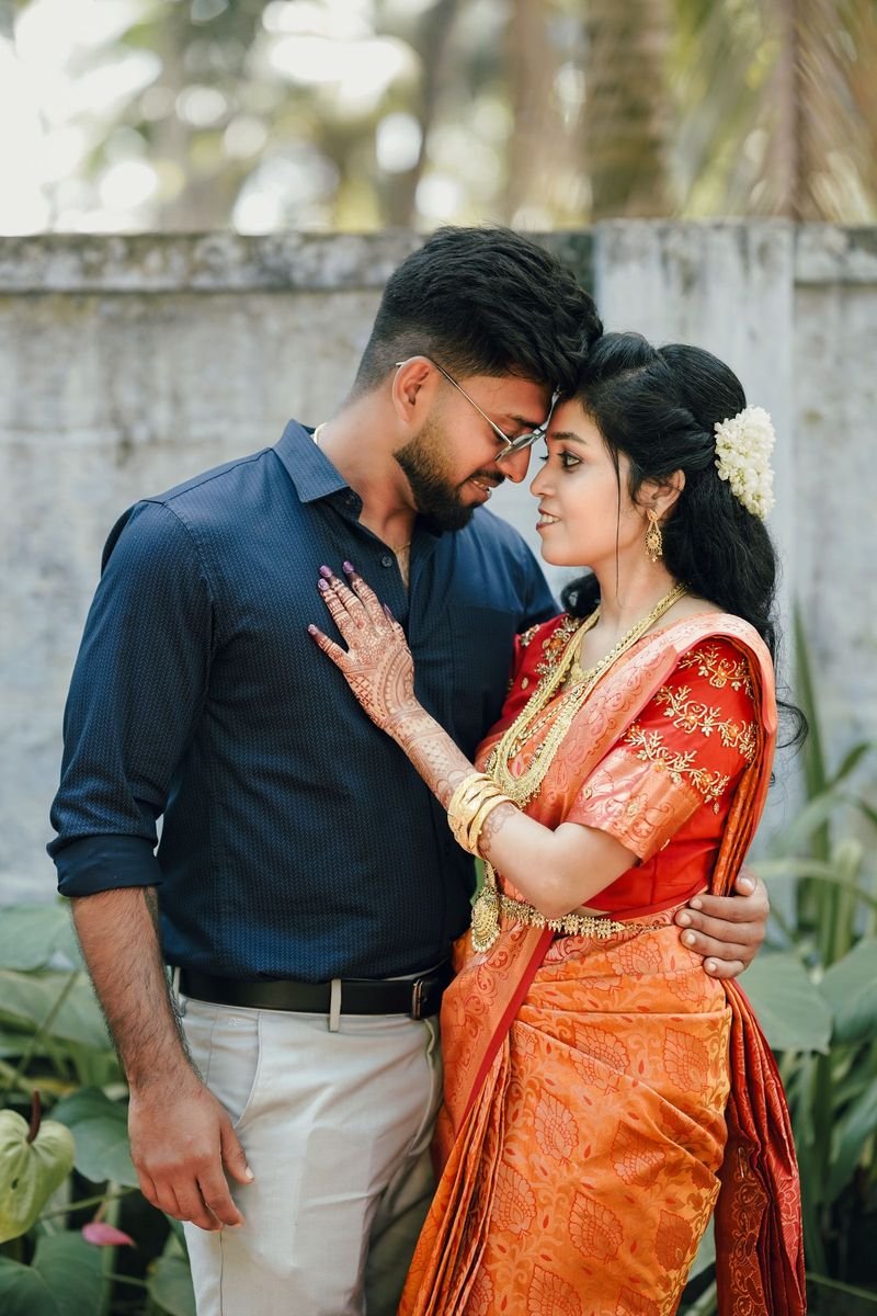 Ananya & Karthik on their wedding day, in garlands and silk