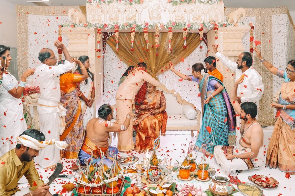 Both families showering petals over the couple at the mandapam